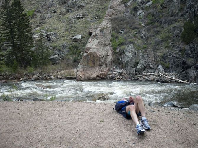 A struggling runner lays by the river (